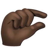 Whatsapp design of the pinching hand: dark skin tone emoji verson:2.23.2.72